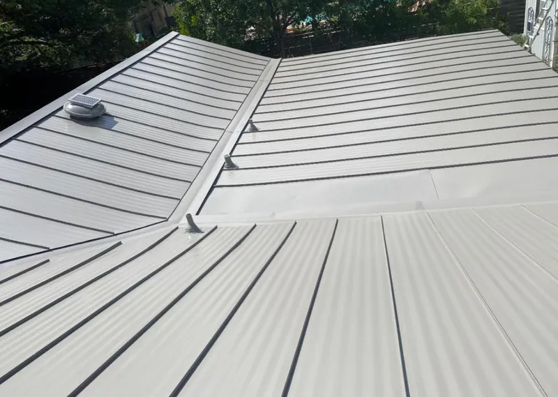 Solar attic fan installed on a metal roof for Roof Ventilation in Chevy Chase