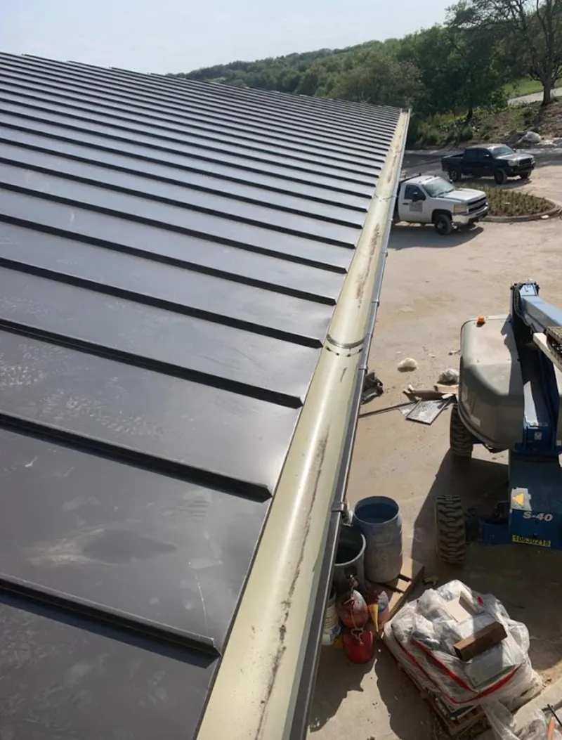 Standing seam panel and gutter detail on a metal roofing jobsite in Chevy Chase